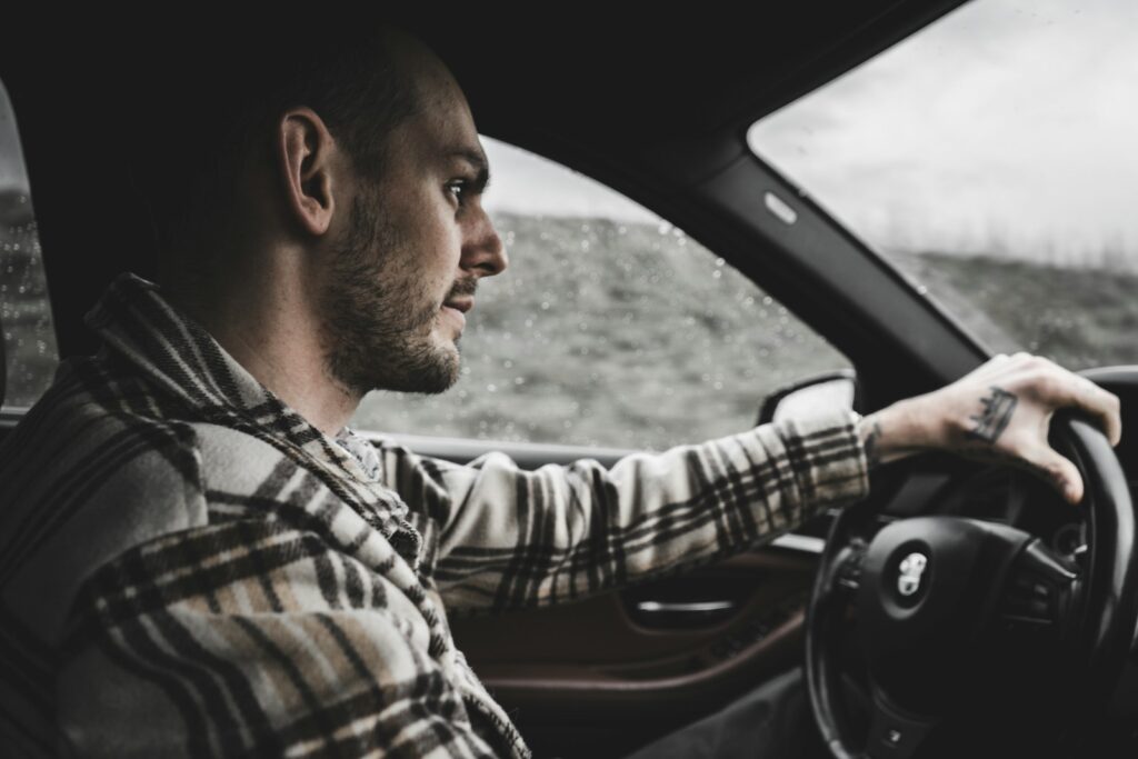 Man driving a car on a rainy day