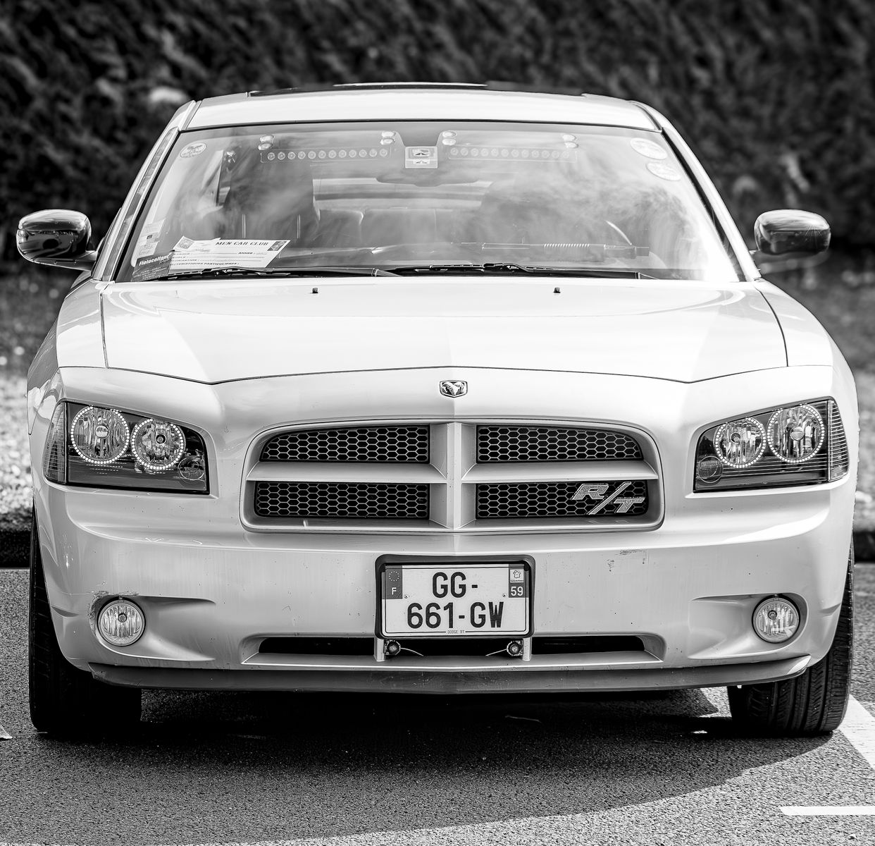 Front view of a classic Dodge Charger displayed in elegant black and white.
