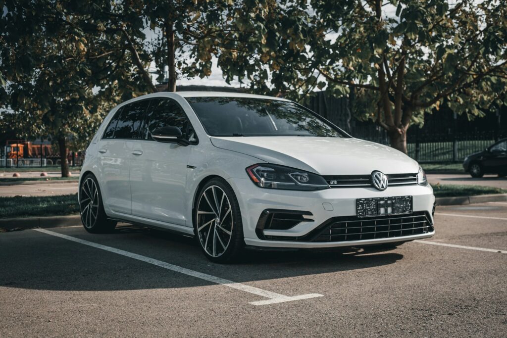 A white car parked in a parking lot