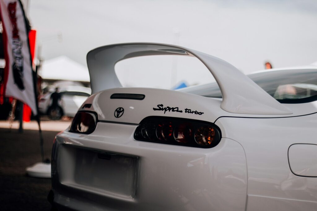 a white sports car parked in a parking lot