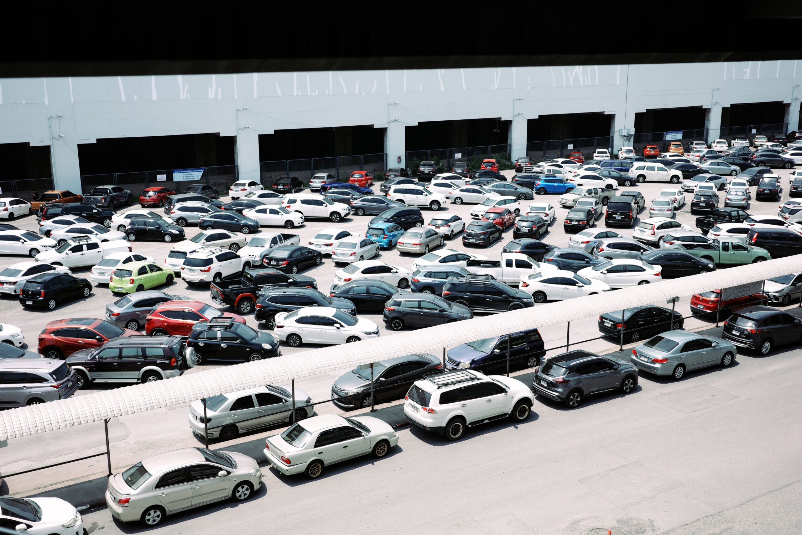 High-angle view of a crowded parking lot filled with parked cars