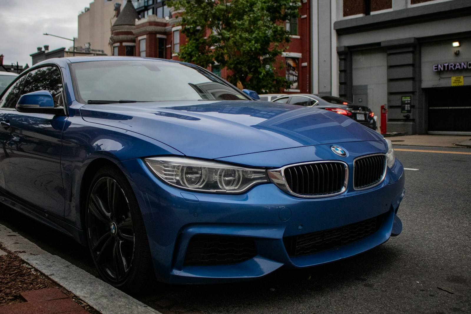 A blue car parked on the side of the road