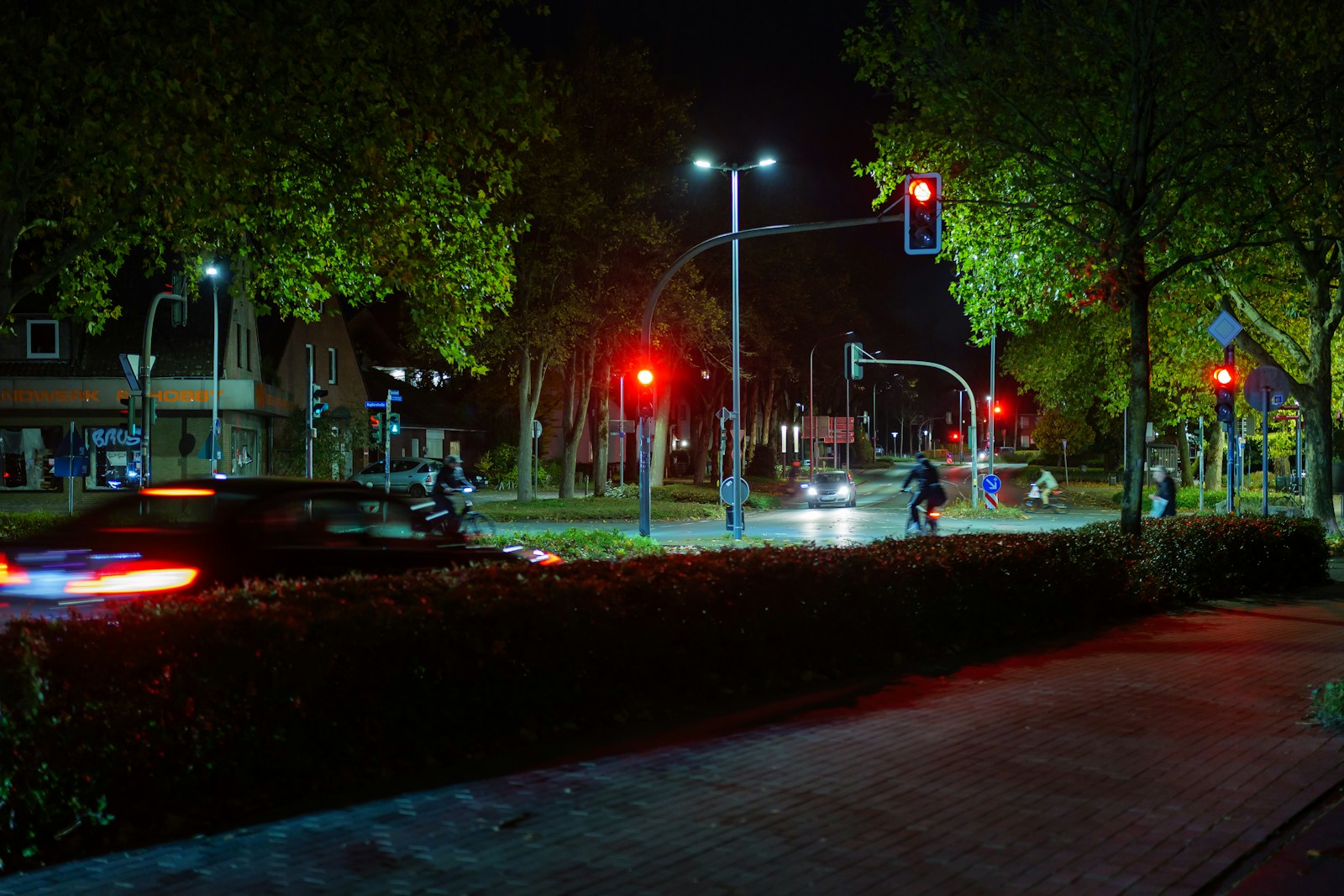 City street at night with traffic lights and trees