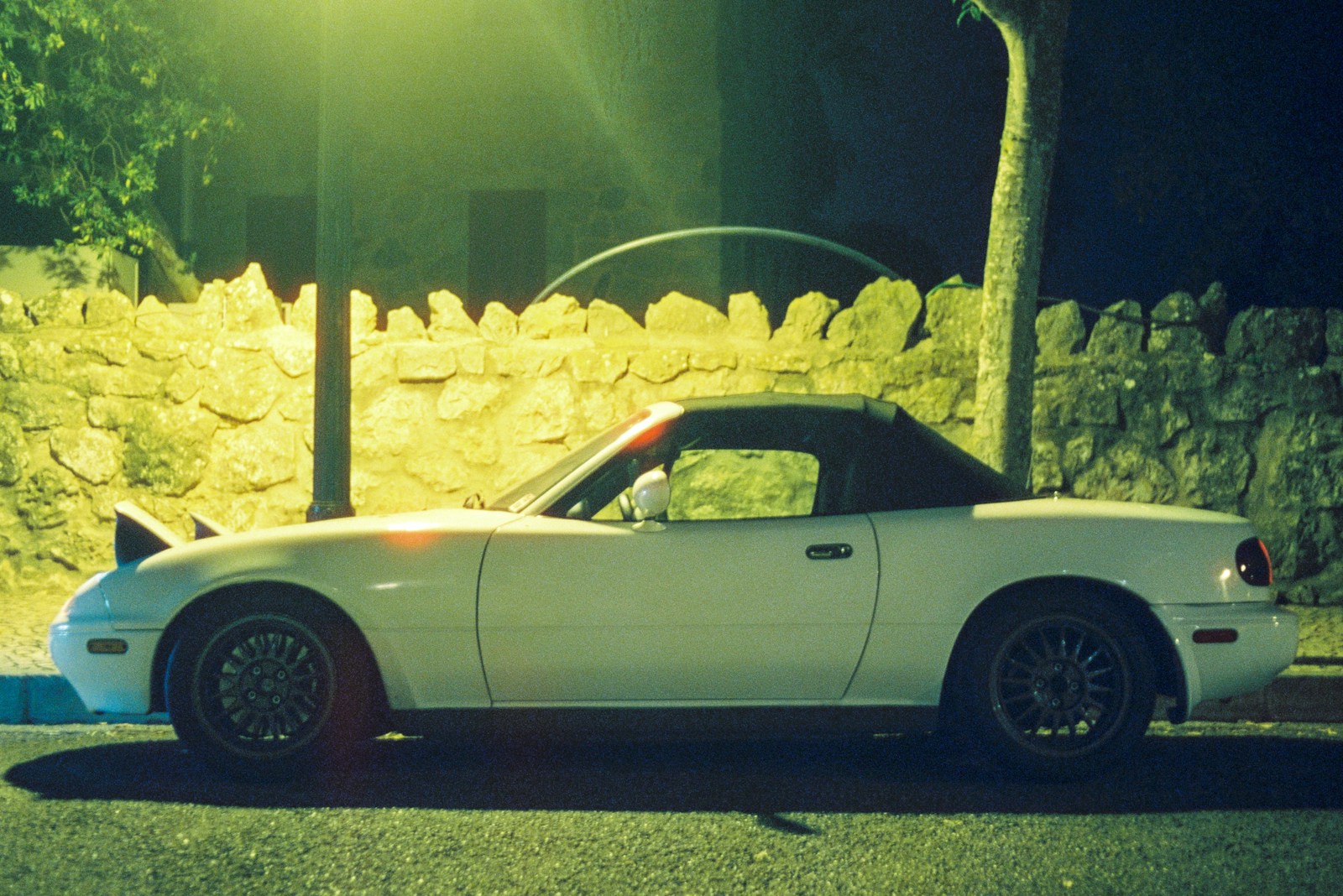 a white car parked on the side of a road