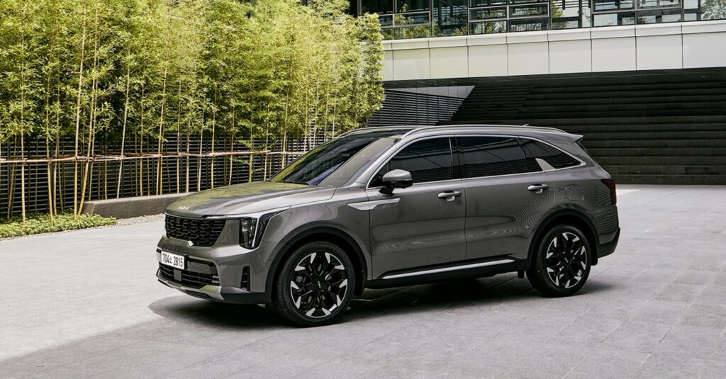 a grey suv parked in front of a building