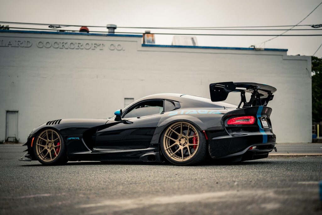 A sleek black sports car with a large spoiler