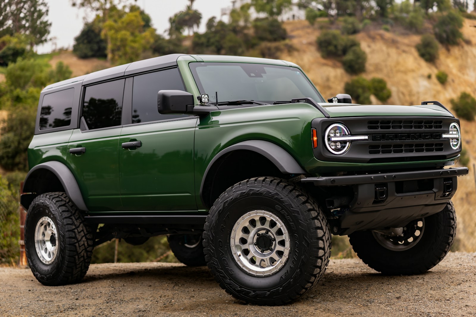 A green ford bronco suv is parked outdoors
