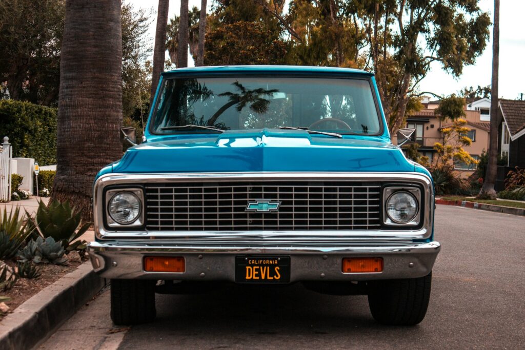a blue car parked on the side of a road