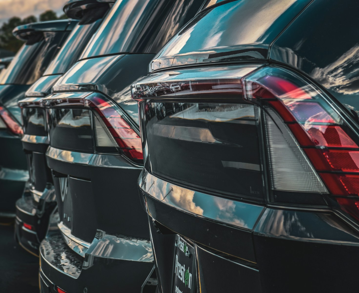 Row of shiny black cars parked in a lot