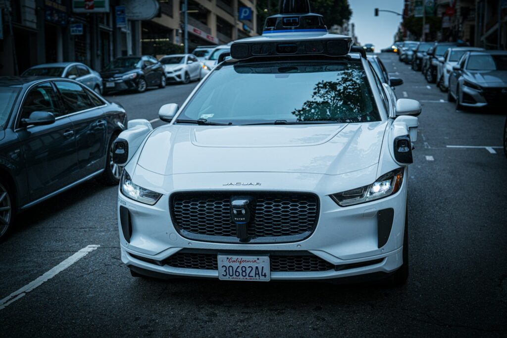 White self-driving car on a city street