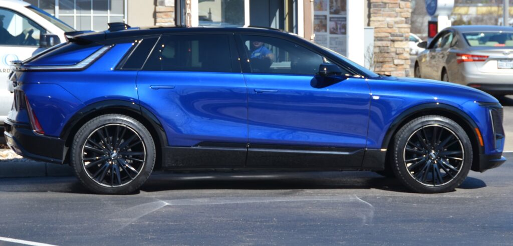 Blue luxury suv parked on a street