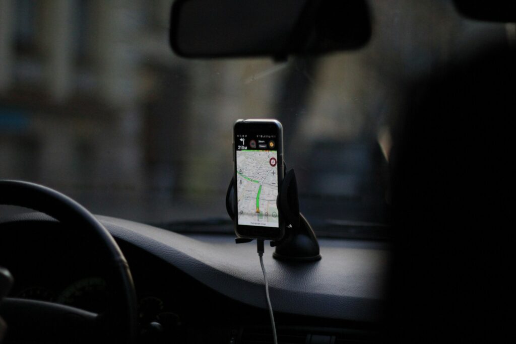 black iphone 4 on car seat