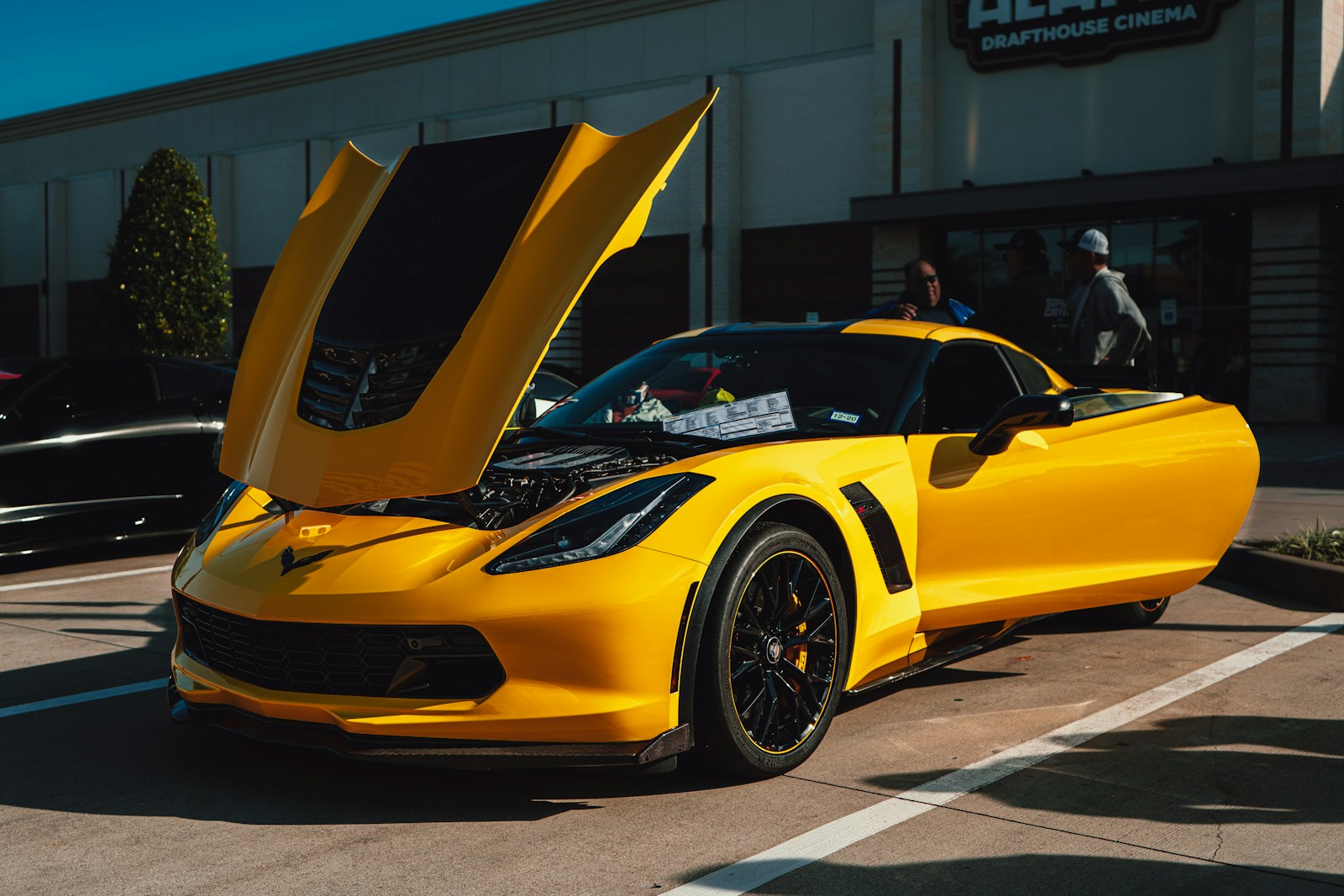 yellow ferrari 458 italia parked near white building