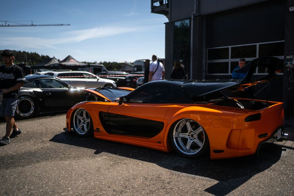 A bright orange car with a large spoiler