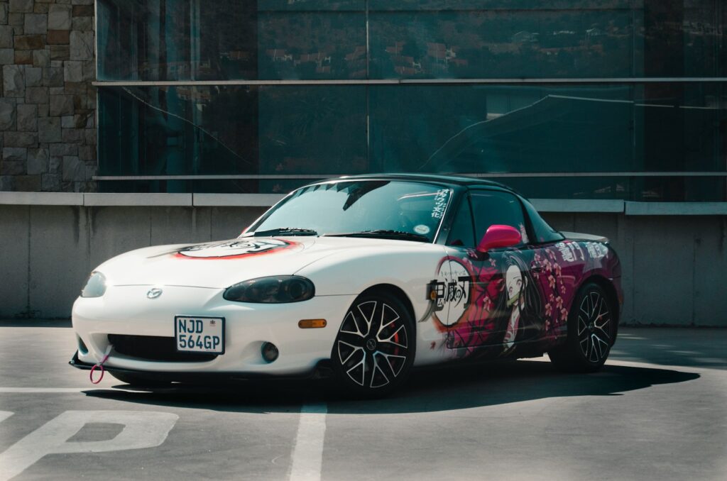 a white sports car parked in a parking lot