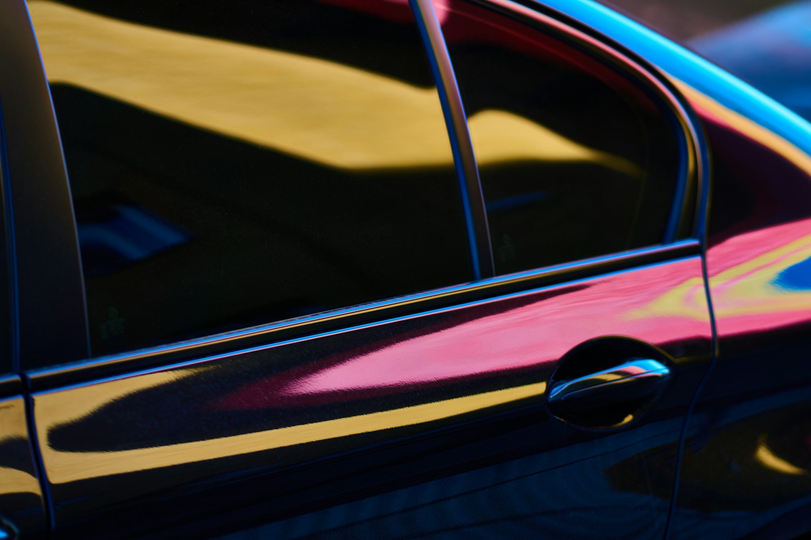 A car reflects colorful lights