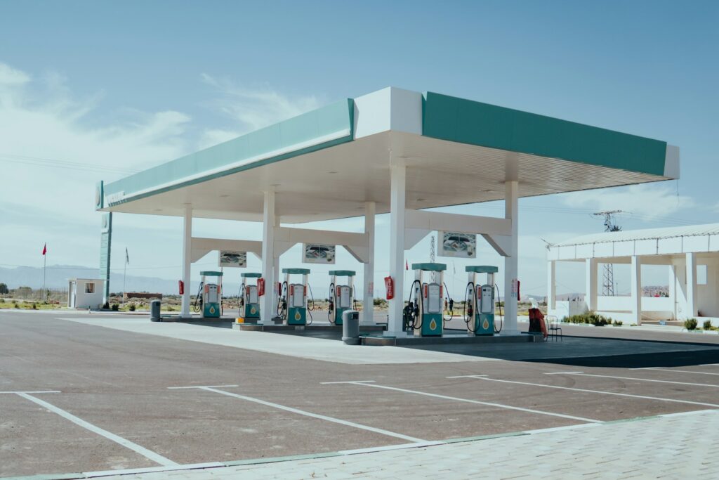 a row of gas pumps sitting in a parking lot