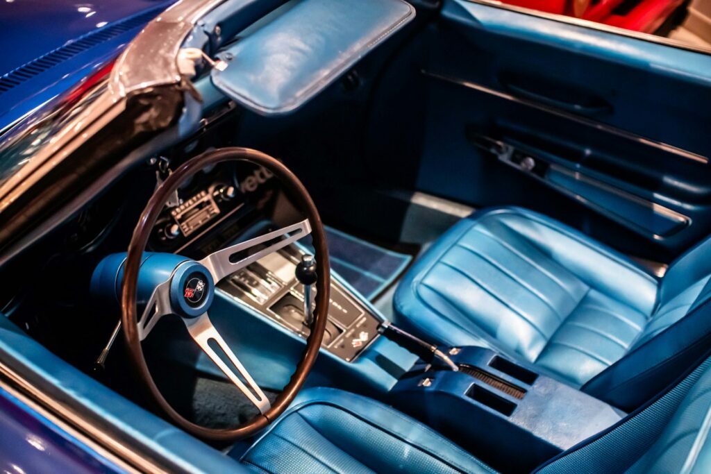 The interior of a classic car with blue leather seats