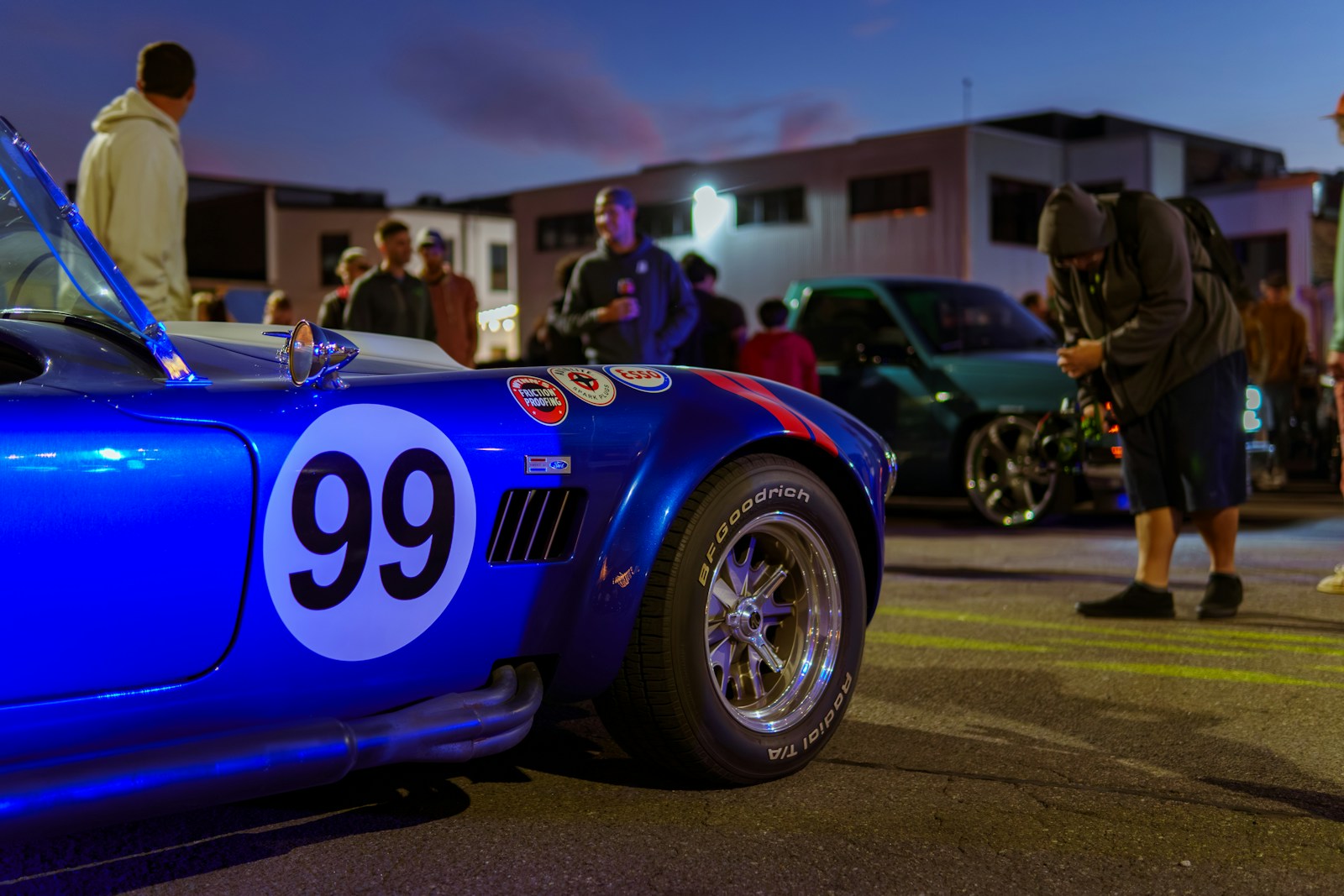 A blue sports car with a number 99 on it