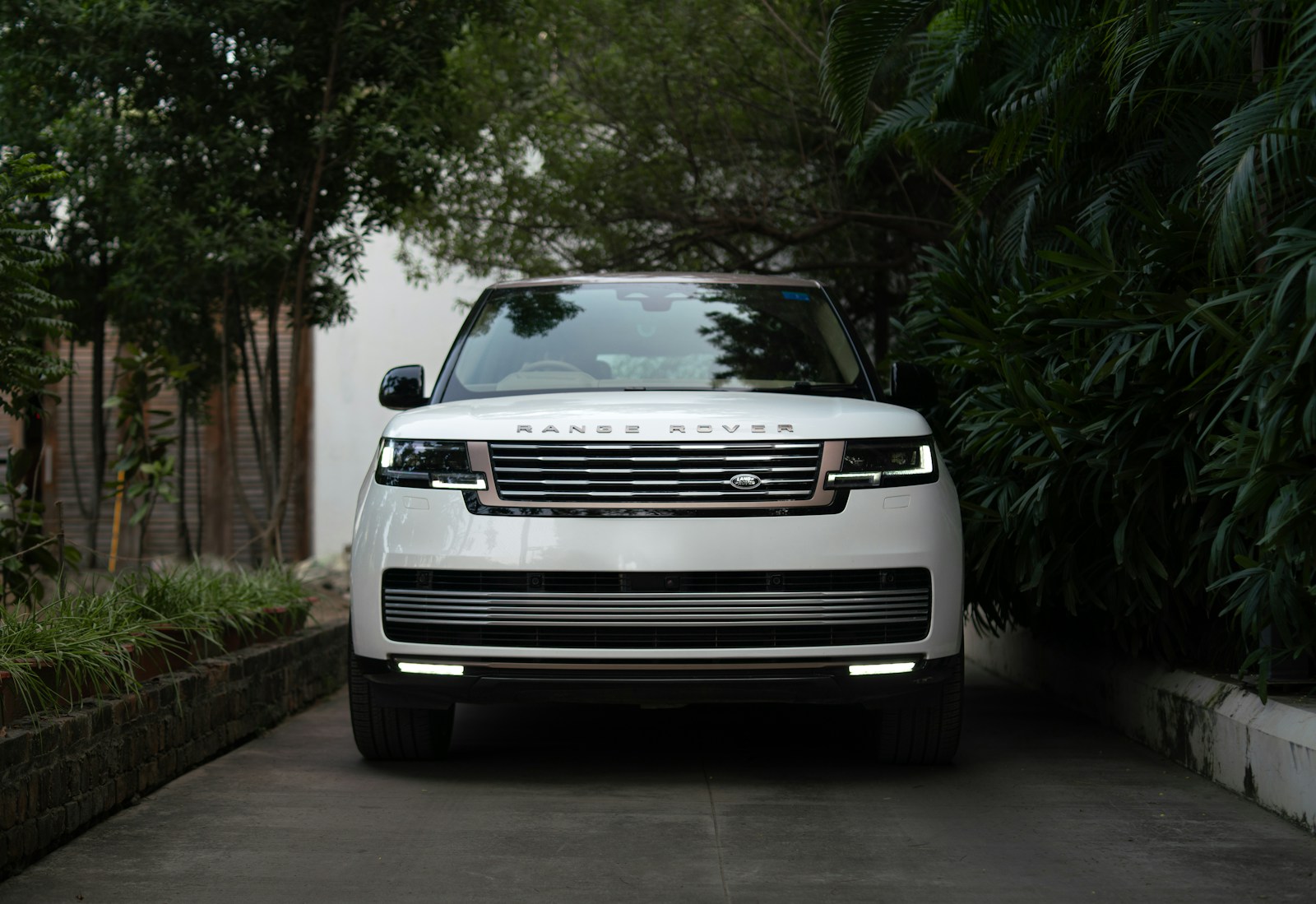 White range rover parked on a paved driveway