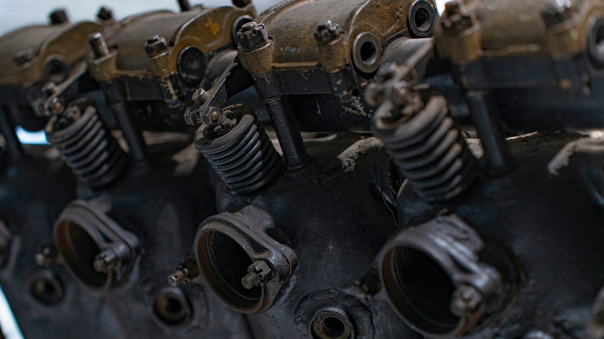 Unsplash photo by Shahabudin Ibragimov showing old engine cylinder heads with springs