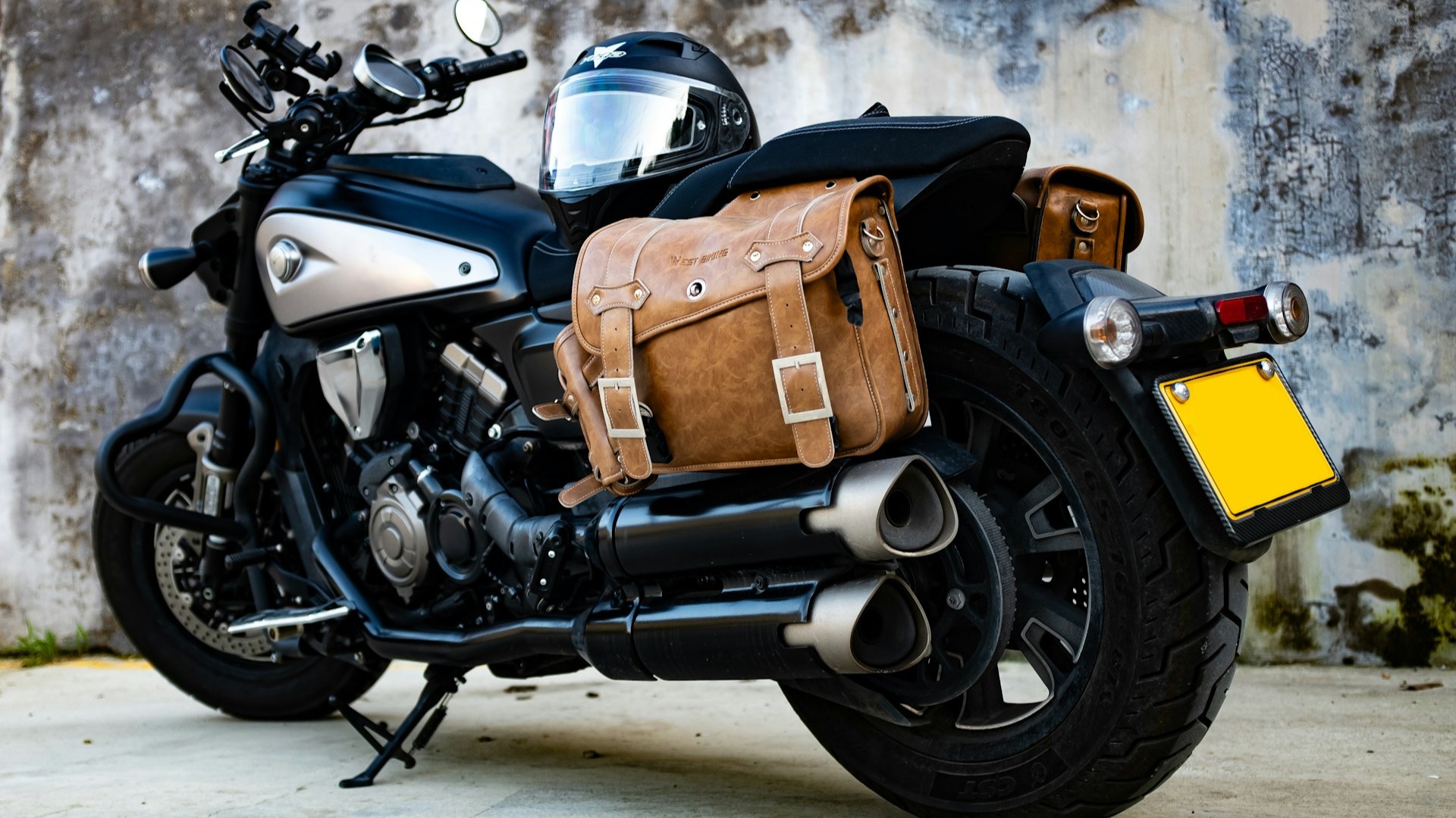 Unsplash photo by Forest Plum showing a motorcycle parked beside a wall with a bag on the back