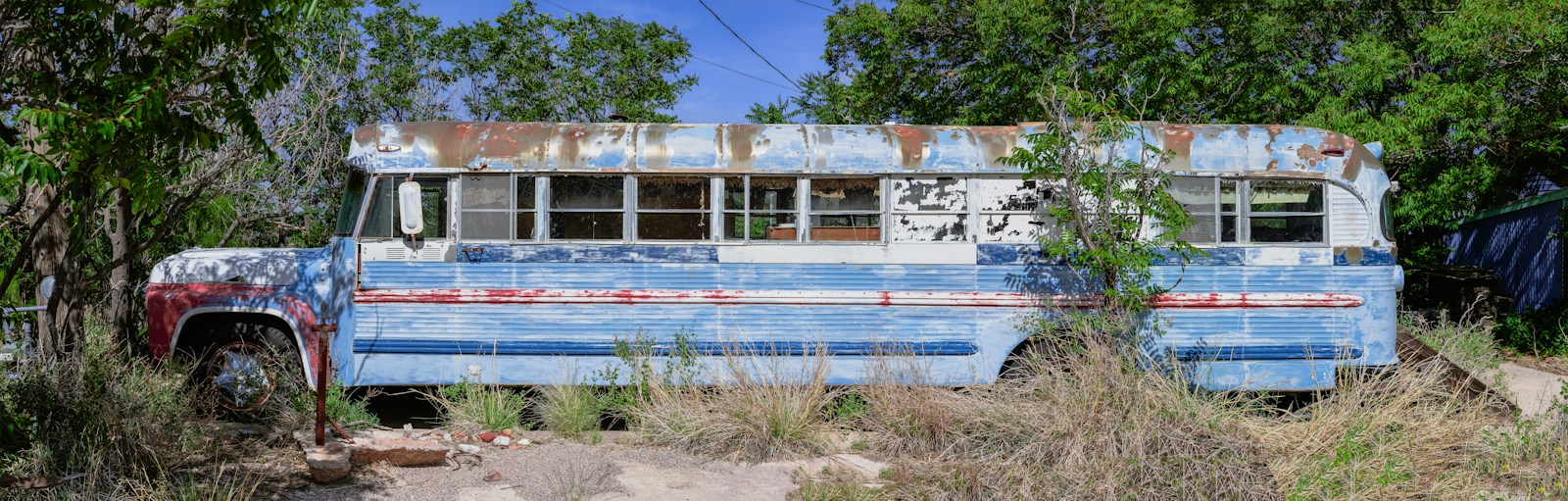 There is an old, abandoned school bus