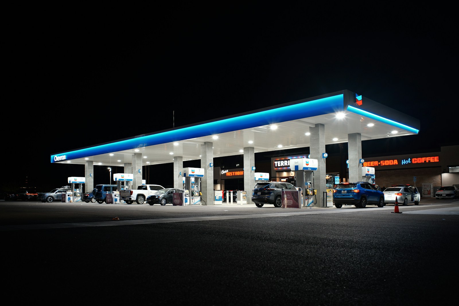 Gas station at night with cars at pumps