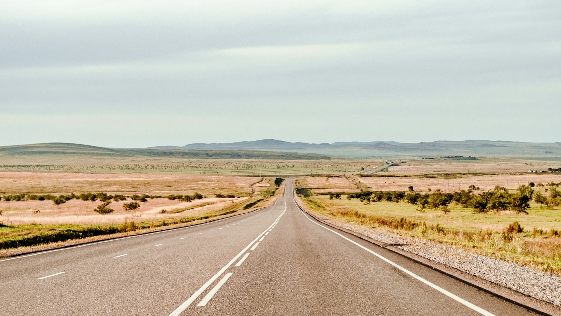 An empty road stretching through open countryside.